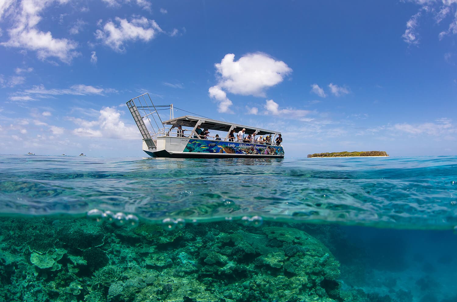 Glass bottom boat over coral